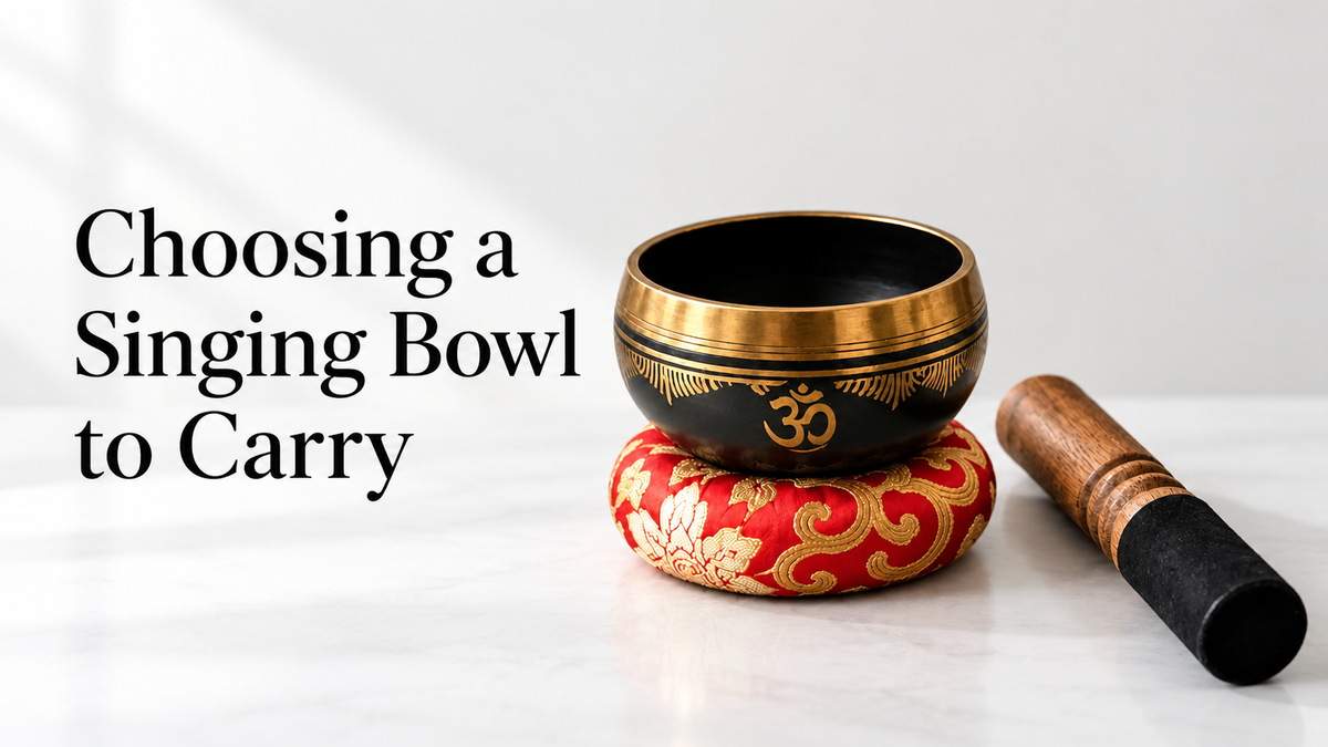 Choosing a Singing Bowl to Carry, with the Yoga Om bowl, ring cushion and striker on a neutral background
