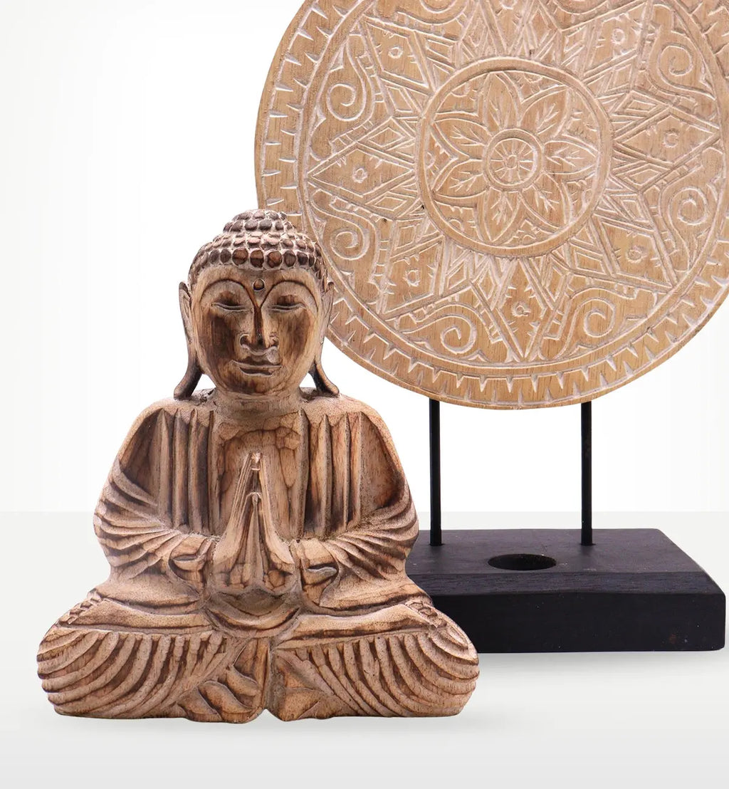 Hand-carved wooden Buddha statue with hands in prayer position in front of an intricately carved mandala on a stand, part of the Buddha Feng Shui Set - Classic Mandala - Natural.