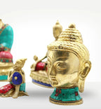 Brass Buddha Figure - Med Head - 8 cm with intricate turquoise inlay, depicting a serene and detailed Buddha head sculpture ideal for spiritual decor and meditation spaces.