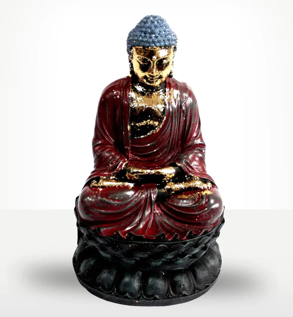 Antique Buddha - Classic Statue featuring a seated figure with a blue hair design, gold detailing on the face and hands, dressed in a deep red robe, resting on a black lotus base.