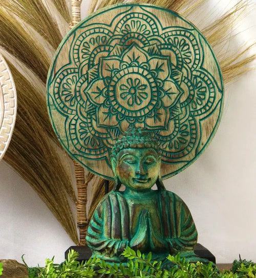 Decorative Buddha statue in green with hands in prayer pose, set against an intricately carved circular wooden mandala, part of the Buddha Feng Shui Set - Buddha Knot - Green.