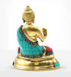 Back view of a Brass Buddha Figure - Blessing - 15cm adorned with turquoise and red inlaid stones, seated on a rounded golden base, exuding serene spiritual elegance.