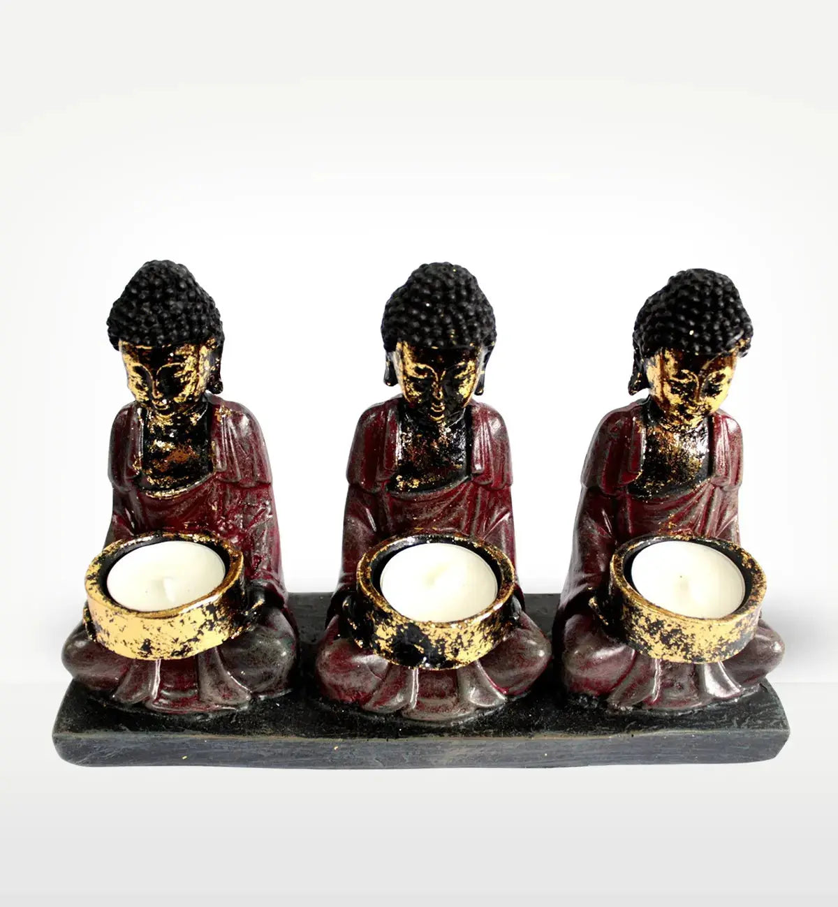 Antique Buddha - Three Devotees Candle Holder featuring three hand-painted Buddha figures in meditative poses holding round candle holders, with a distressed antique finish.