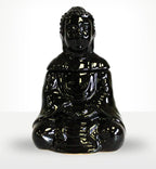 Glossy black ceramic Sitting Buddha Oil Burner - Black in a serene seated pose, reflecting light on its smooth surface, ideal for tranquil home decor.