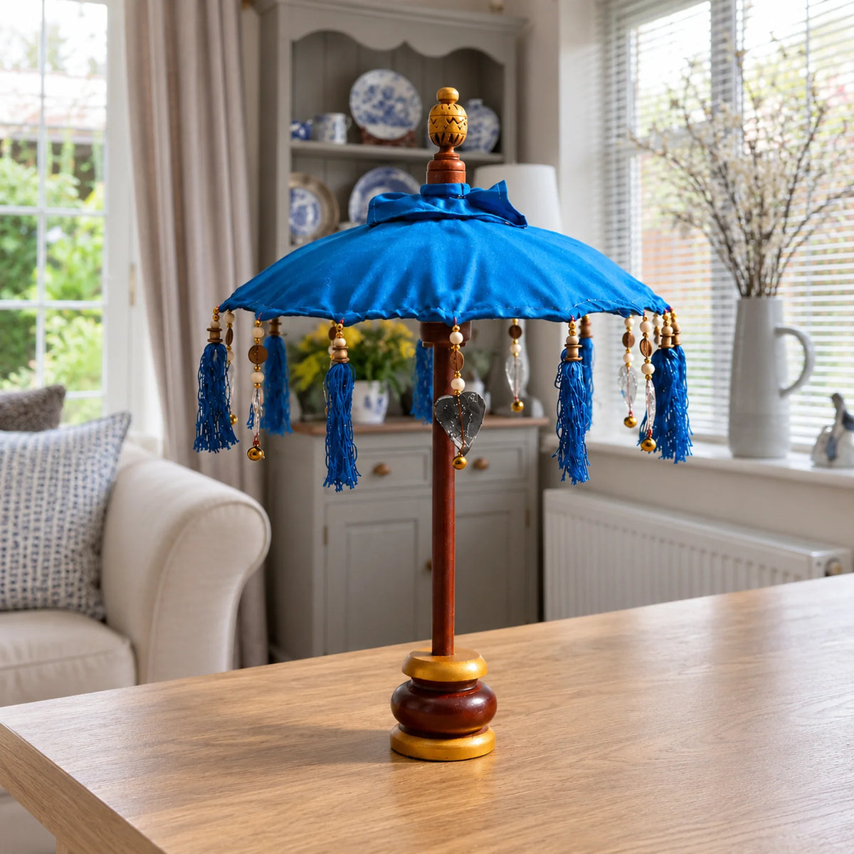 Bali Indoor Umbrella Home Decor Parasol, Cotton, Turquoise- 40cm on a desk in a British sitting room.