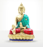 Brass Buddha Figure - Hands Down - 11.5 cm seated with a calm expression, adorned with turquoise and red inlaid detailing, showcasing intricate brass craftsmanship and Buddha decor.