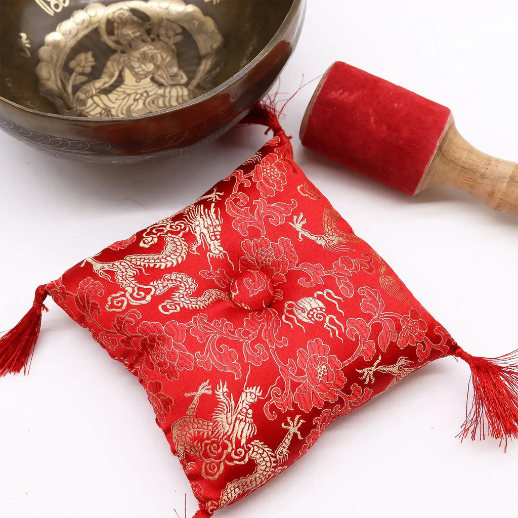 Brass Golden Tara - Special S'Bowl Set featuring a brass singing bowl with intricate engraving, a red velvet mallet, and a decorative red cushion with gold patterns.