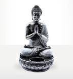 Buddha Candle Holder - White - Medium featuring a serene hand-carved Buddha statue in meditation pose with hands pressed together, designed as a decorative resin candle holder.