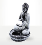 Buddha Candle Holder - White - Medium featuring a hand-carved resin Buddha statue in a meditative pose with a circular base designed to hold a candle, ideal for serene Buddha decor.
