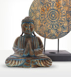 Buddha Feng Shui Set - Flower Mandala - Blue featuring a serene blue-toned Buddha statue in a meditative pose with hands in prayer, paired with a detailed flower mandala on a stand.