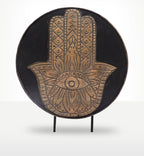 Decorative grey Buddha Feng Shui Set - Hamsa featuring a hand-carved wooden Hamsa symbol with intricate patterns and an eye motif, presented on a stand for Buddha decor.