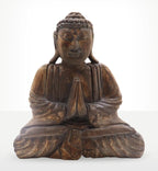 Buddha Feng Shui Set - Om - Grey & Black depicting a hand-carved Buddha statue in a meditative pose with hands in prayer, crafted with detailed grooves and a rustic finish.