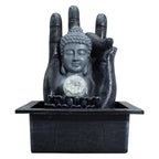 Statue of Buddha within a hand holding a crystal ball on a white background