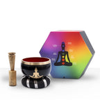 Buddha Singing Bowl Set- Black/Orange 10.7cm includes a black and orange singing bowl with a golden Buddha silhouette, wooden striker, cushion, and rainbow-colored chakra guide box.