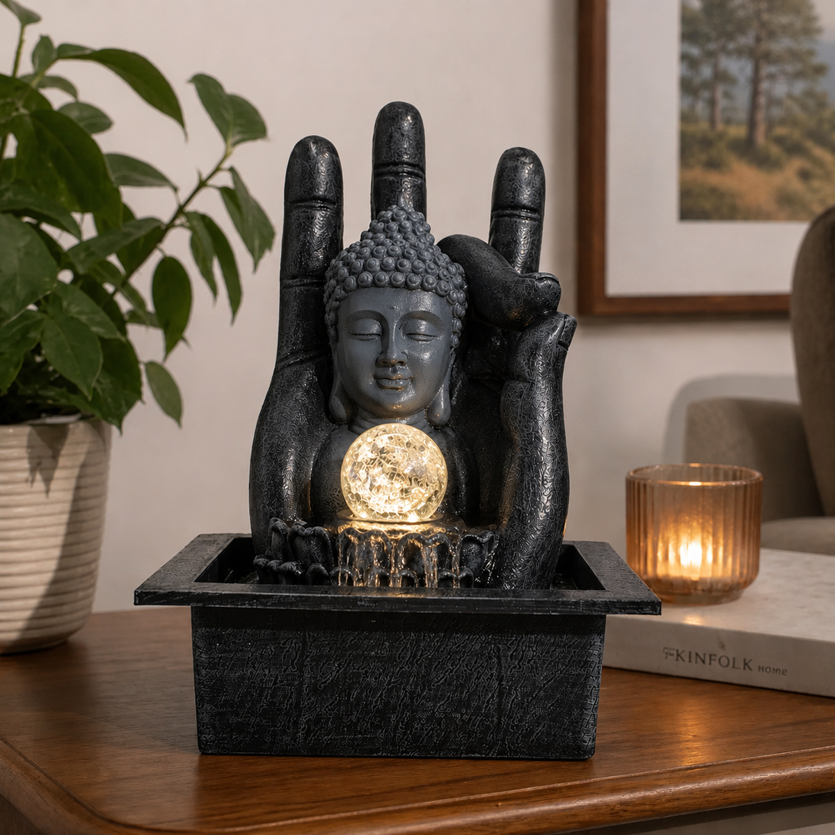 Buddha Hand & Head Tabletop Water Feature (20x25x35cm) with a serene Buddha head resting against a large hand, featuring a glowing orb and flowing water on a wooden table.