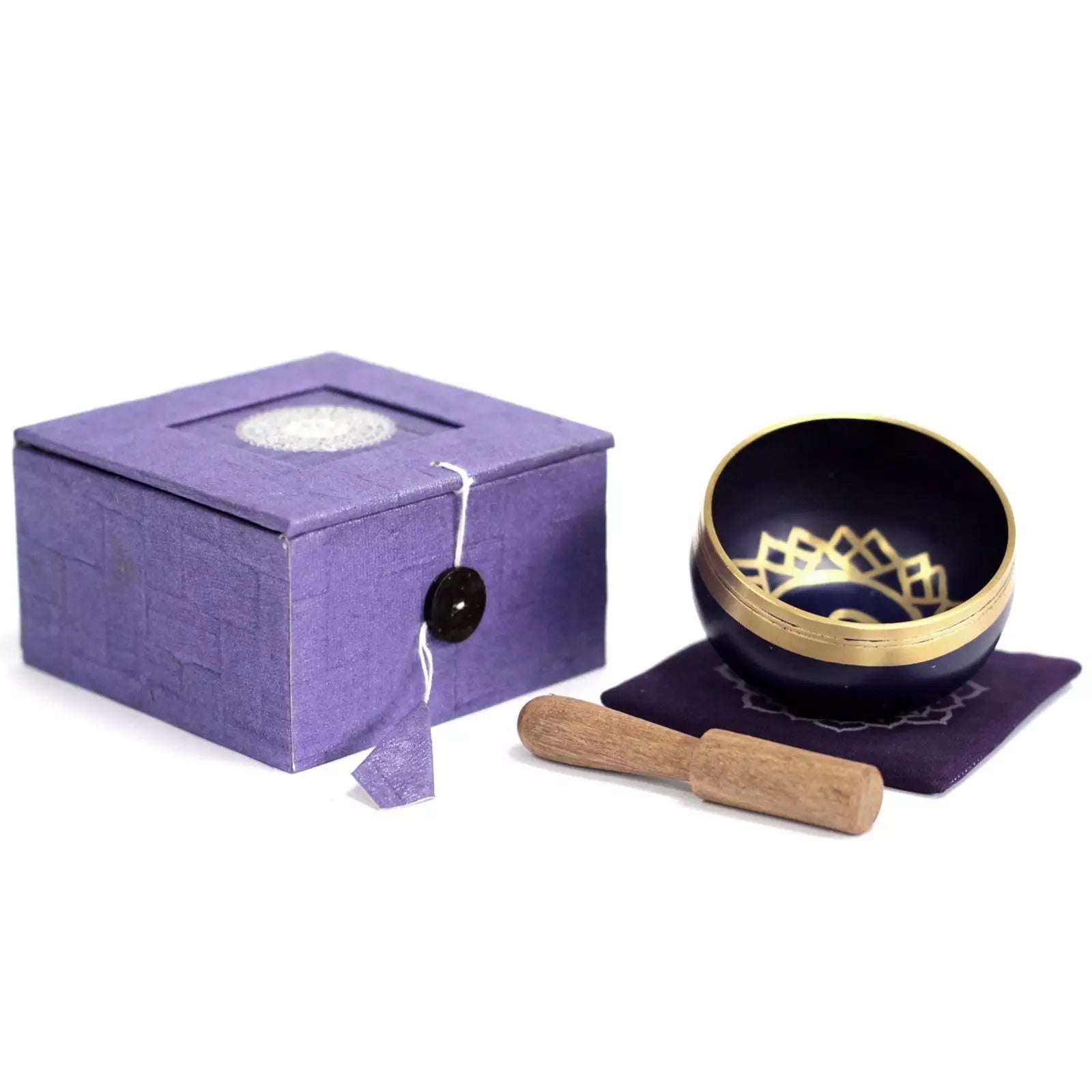 Navy singing bowl with gold interior and wooden striker on a white background