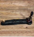Antique Buddha - Incense Burner & Box featuring a detailed seated Buddha figure in dark resin with gold and red accents, designed for holding incense cones or sticks with a floral patterned base.