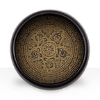 Earth Powder Singing Bowl - Mantra Five Buddha - 16cm featuring intricate golden floral and symbolic patterns etched inside a dark round bowl with a spiritual design.