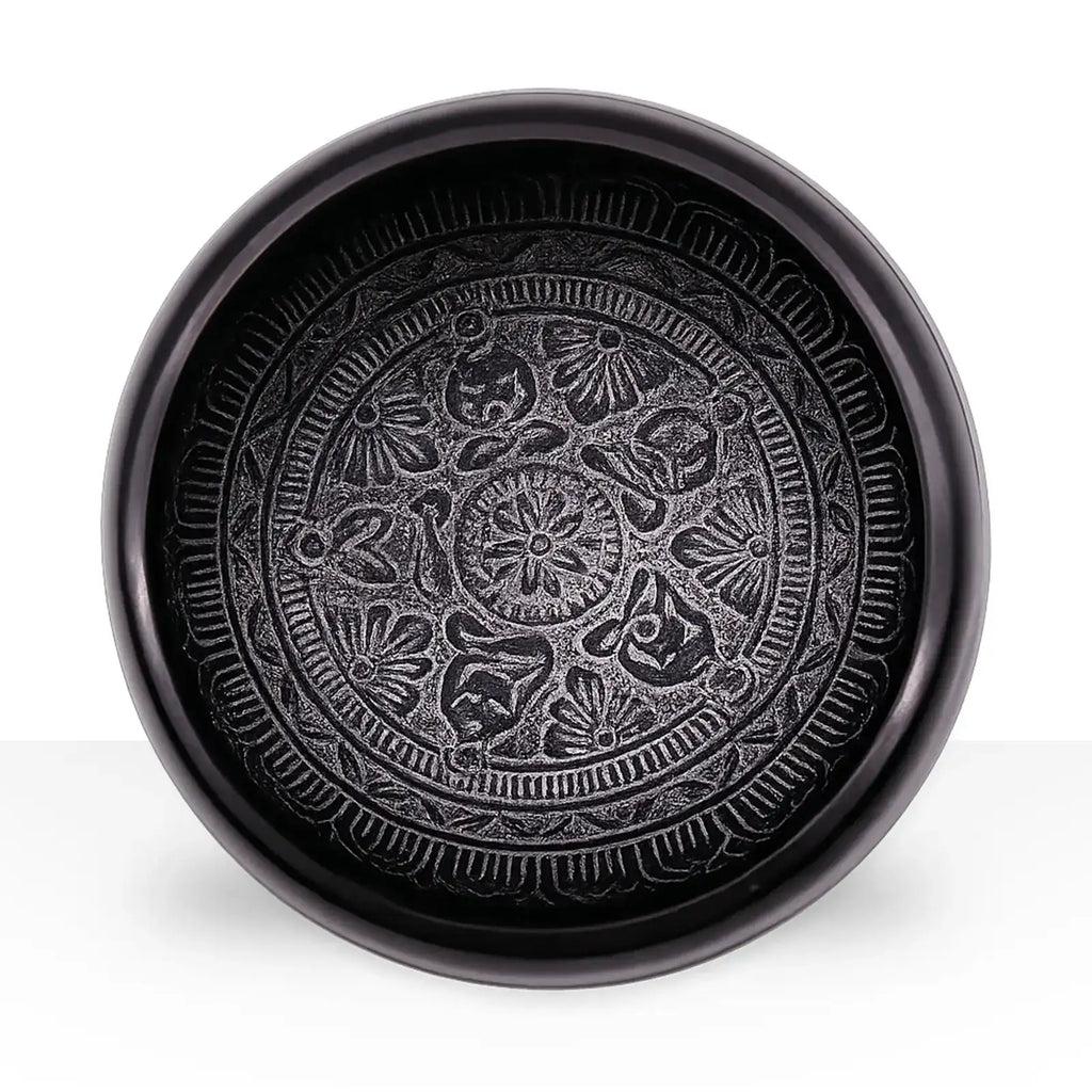 Earth Powder Singing Bowl - Om Five Buddha - 16cm featuring intricate circular patterns with symbolic Om and Buddha motifs engraved in a dark, polished surface.