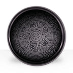 Earth Powder Singing Bowl - Om Five Buddha - 16cm featuring intricate circular patterns with symbolic Om and Buddha motifs engraved in a dark, polished surface.