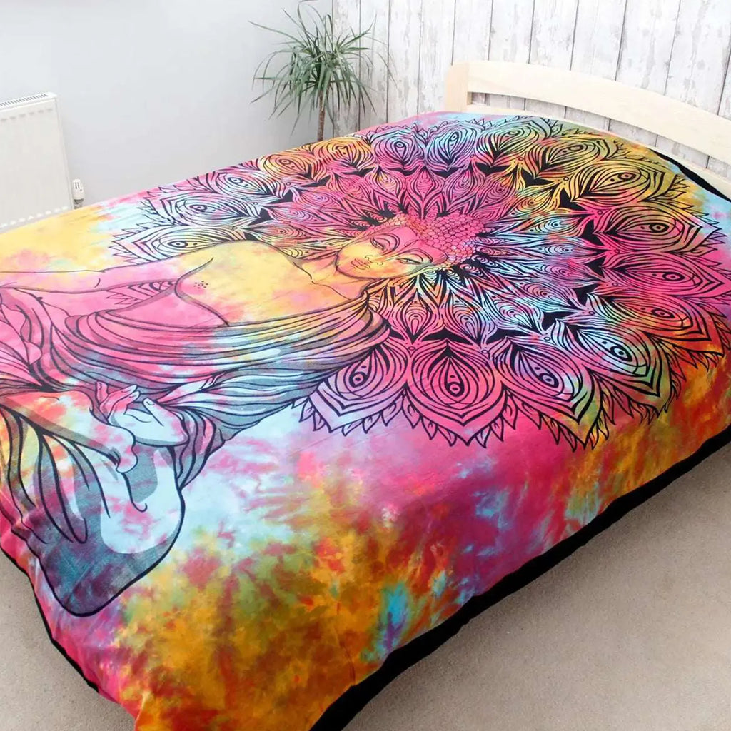 Double Cotton Bedspread + Wall Hanging - Peaceful Buddha features a vibrant tie-dye background with a detailed black Buddha figure and intricate mandala design, displayed in a cozy natural room setting.