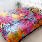 Double Cotton Bedspread + Wall Hanging - Peaceful Buddha features a vibrant tie-dye background with a detailed black Buddha figure and intricate mandala design, displayed in a cozy natural room setting.