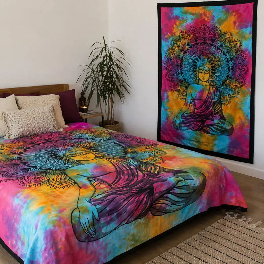Double Cotton Bedspread + Wall Hanging - Peaceful Buddha features a vibrant tie-dye background with a detailed black Buddha figure and intricate mandala design, displayed in a cozy natural room setting.