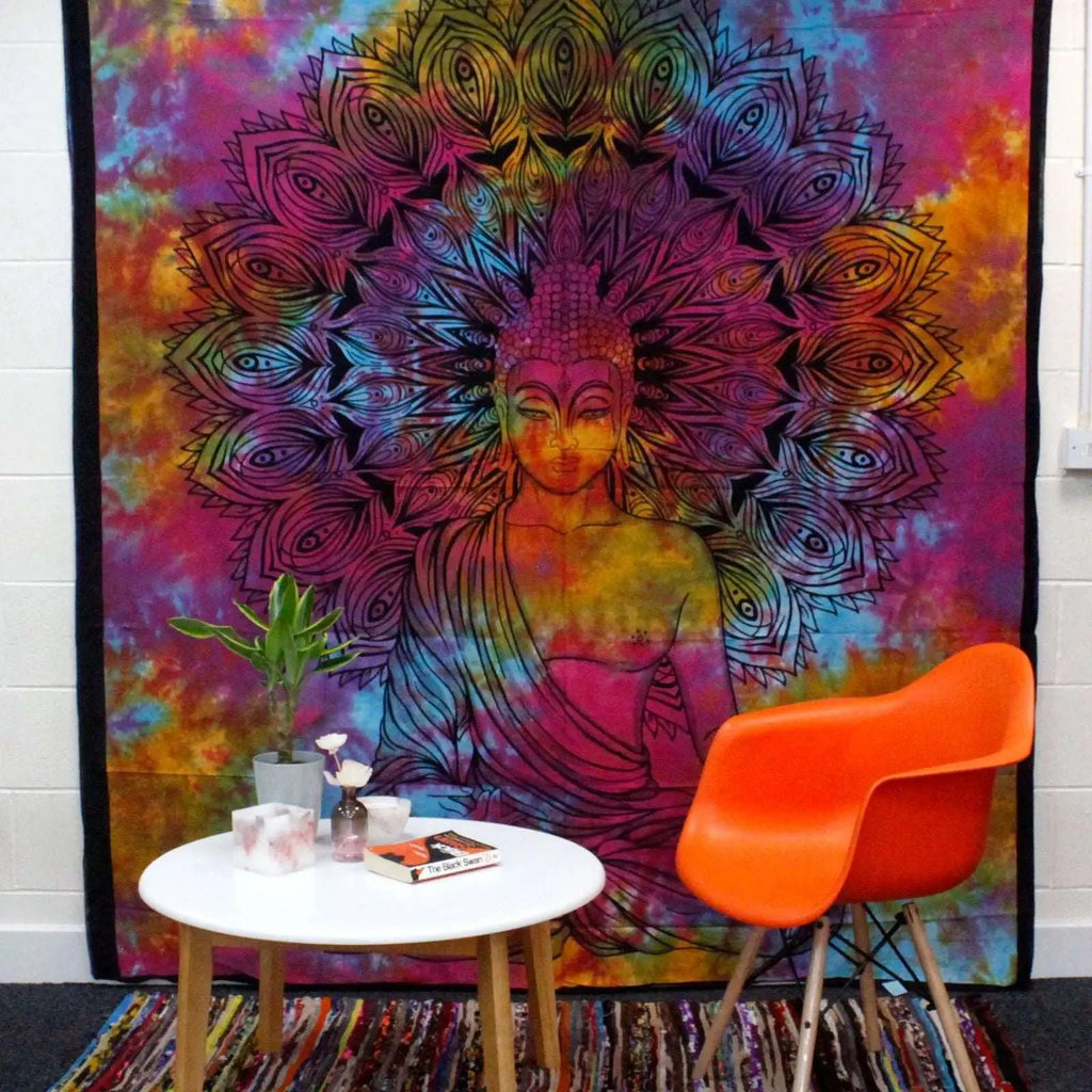 Double Cotton Bedspread + Wall Hanging - Peaceful Buddha features a vibrant tie-dye background with a detailed black Buddha figure and intricate mandala design, displayed in a cozy natural room setting.