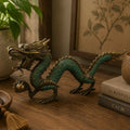 Fengshui - Med Dragon with Ball - 27cm featuring a detailed green and brass finish dragon sculpture holding a ball, displayed on a wooden surface with cozy home decor surroundings.