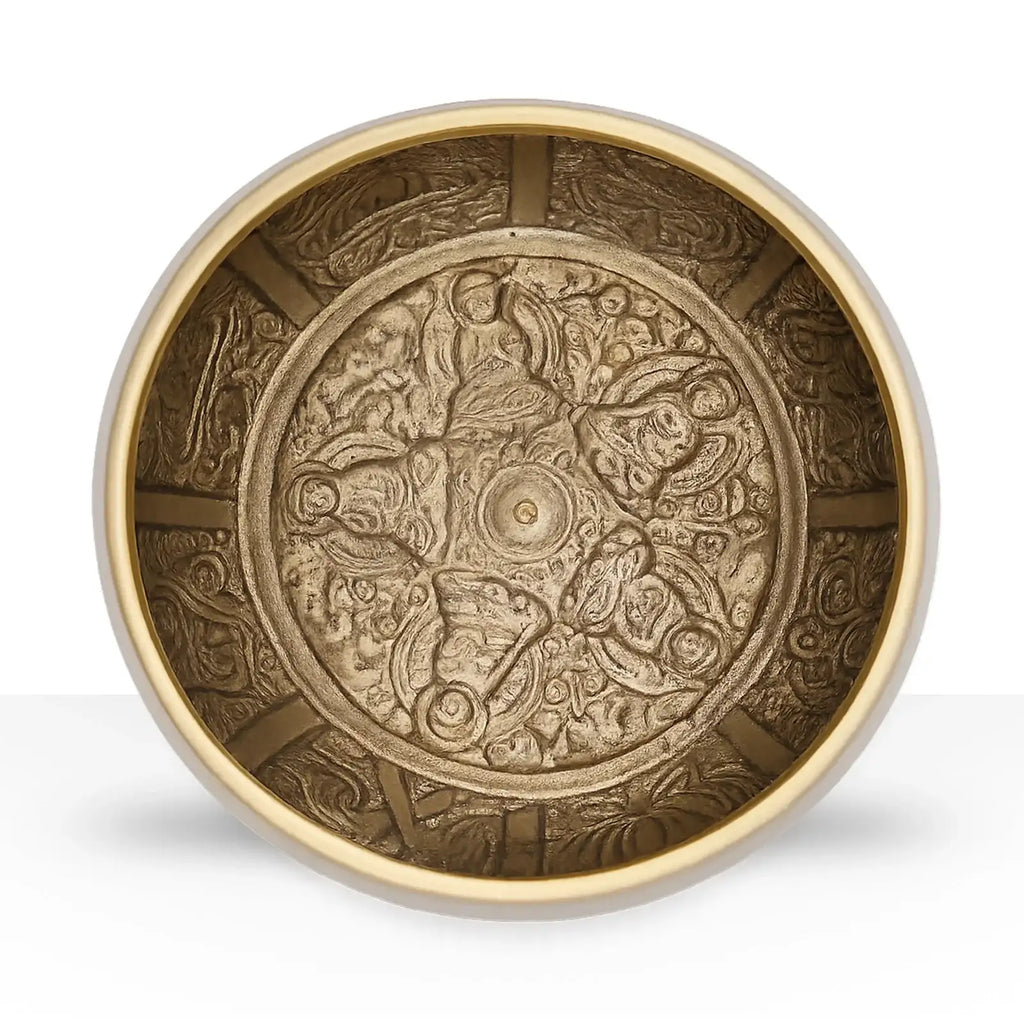 Five Buddha Singing Bowl featuring intricate engraved brass figures of five Buddhas in a circular pattern with detailed traditional motifs on the inner surface.
