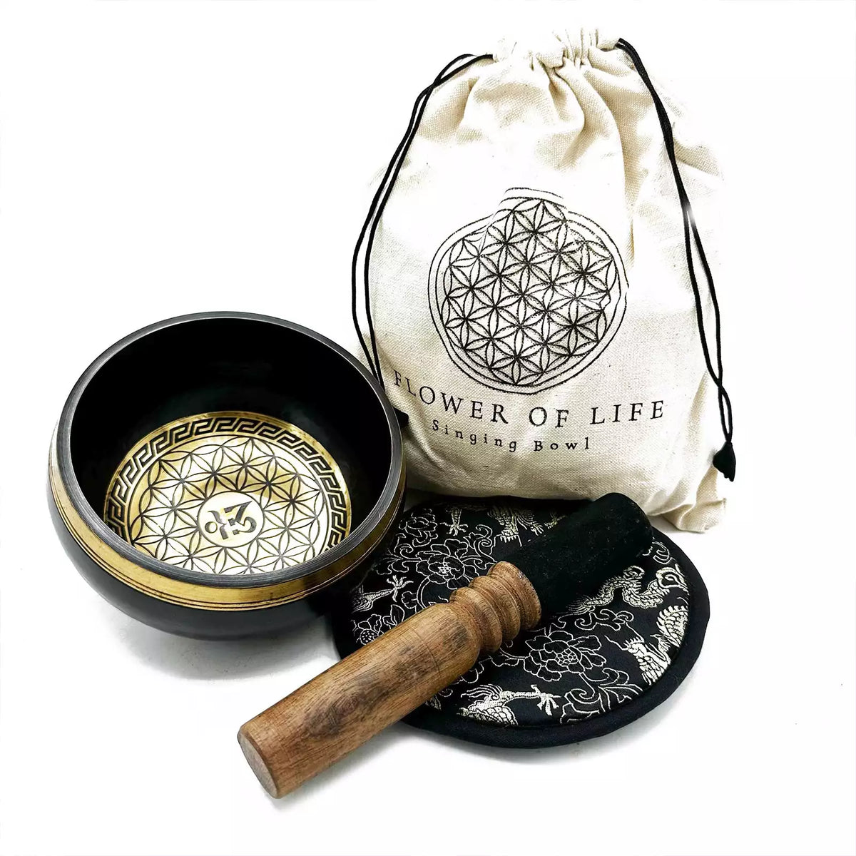 Singing bowl set with a drumstick and pouch on a white background