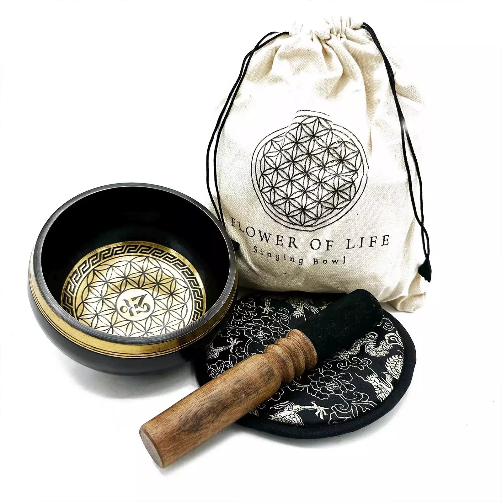 Singing bowl set with a drumstick and pouch on a white background