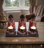 Antique Buddha - Three Devotees Candle Holder featuring three intricately detailed Buddha figures holding lit candles, designed for serene and elegant Buddha decor.