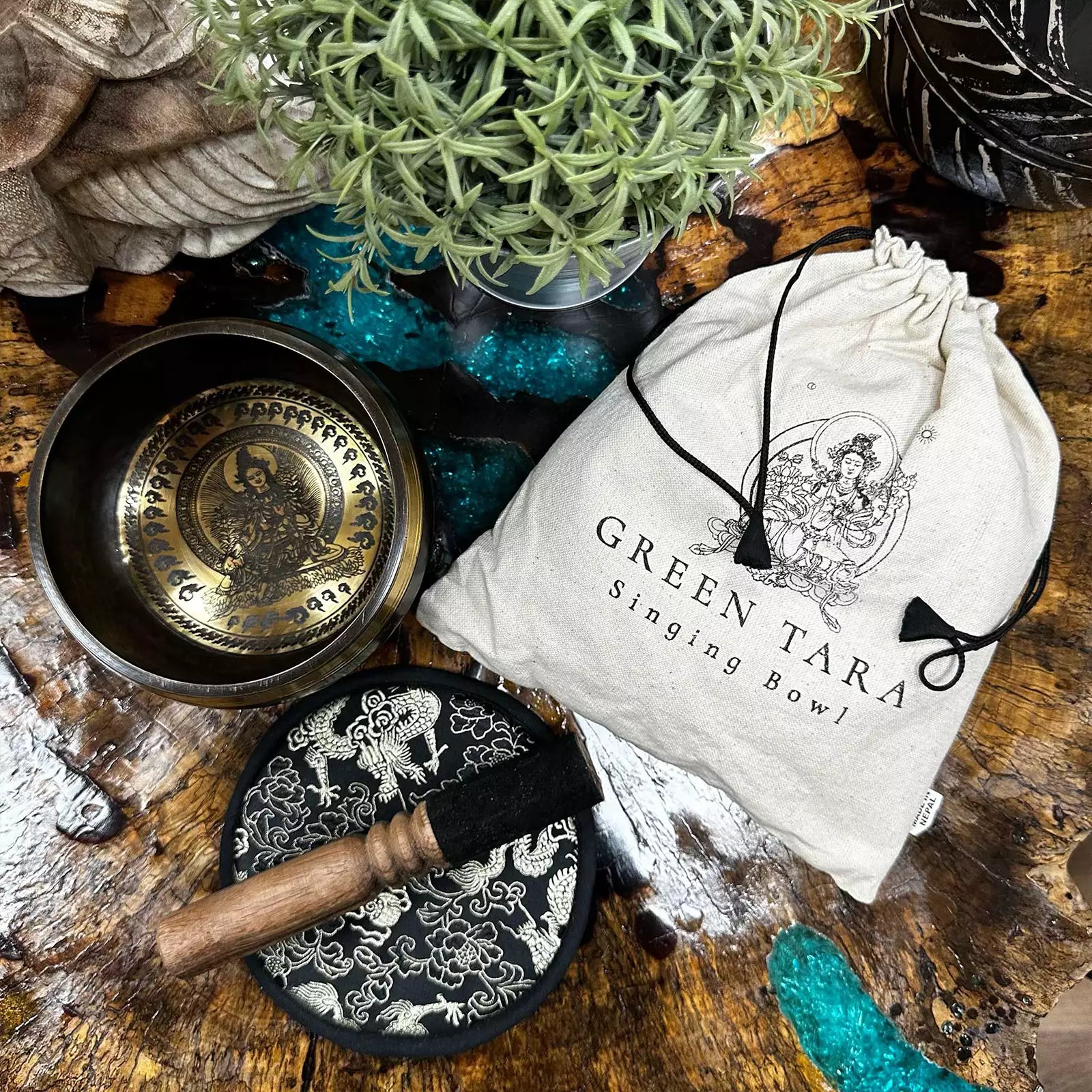 Singing bowl set with packaging on a wooden surface