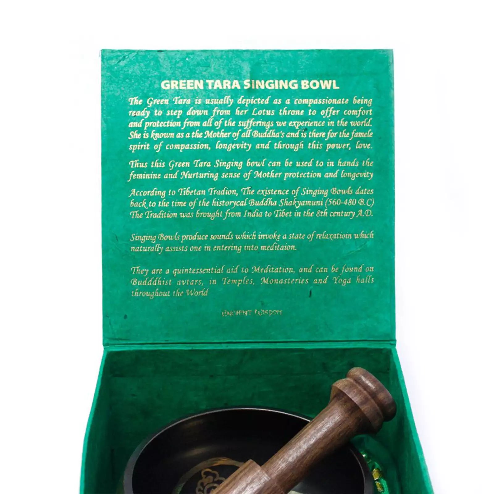 Open green presentation box containing a dark green singing bowl and a wooden mallet, with printed text on the inner lid describing the Green Tara singing bowl.