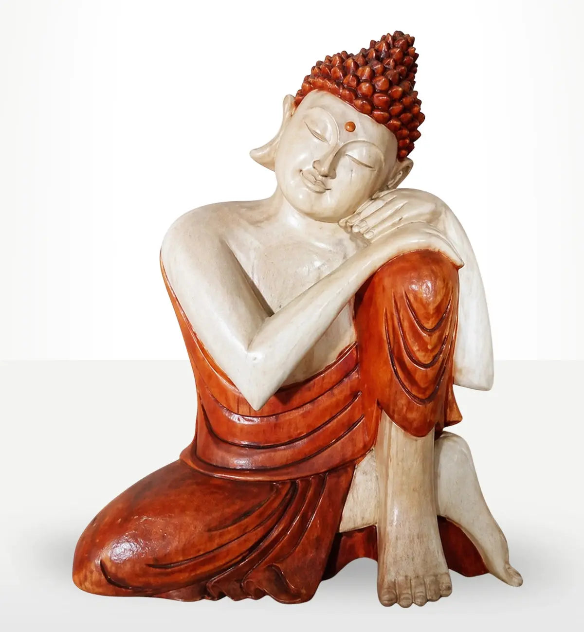 Hand Carved Buddha Statue - 25cm Thinking showing a serene Buddha figure with closed eyes and a peaceful expression, resting the head on folded arms over bent knee, carved in natural and reddish tones.