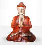 Hand Carved Buddha Statue - 30cm Welcome depicting a serene seated Buddha in a prayer pose, featuring detailed craftsmanship and rich reddish-brown and cream tones.
