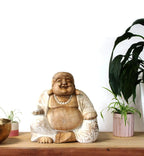 Happy Buddha - Whitewash 30cm hand carved resin Buddha statue in a whitewashed finish, displayed on a wooden surface with green plants in the background.