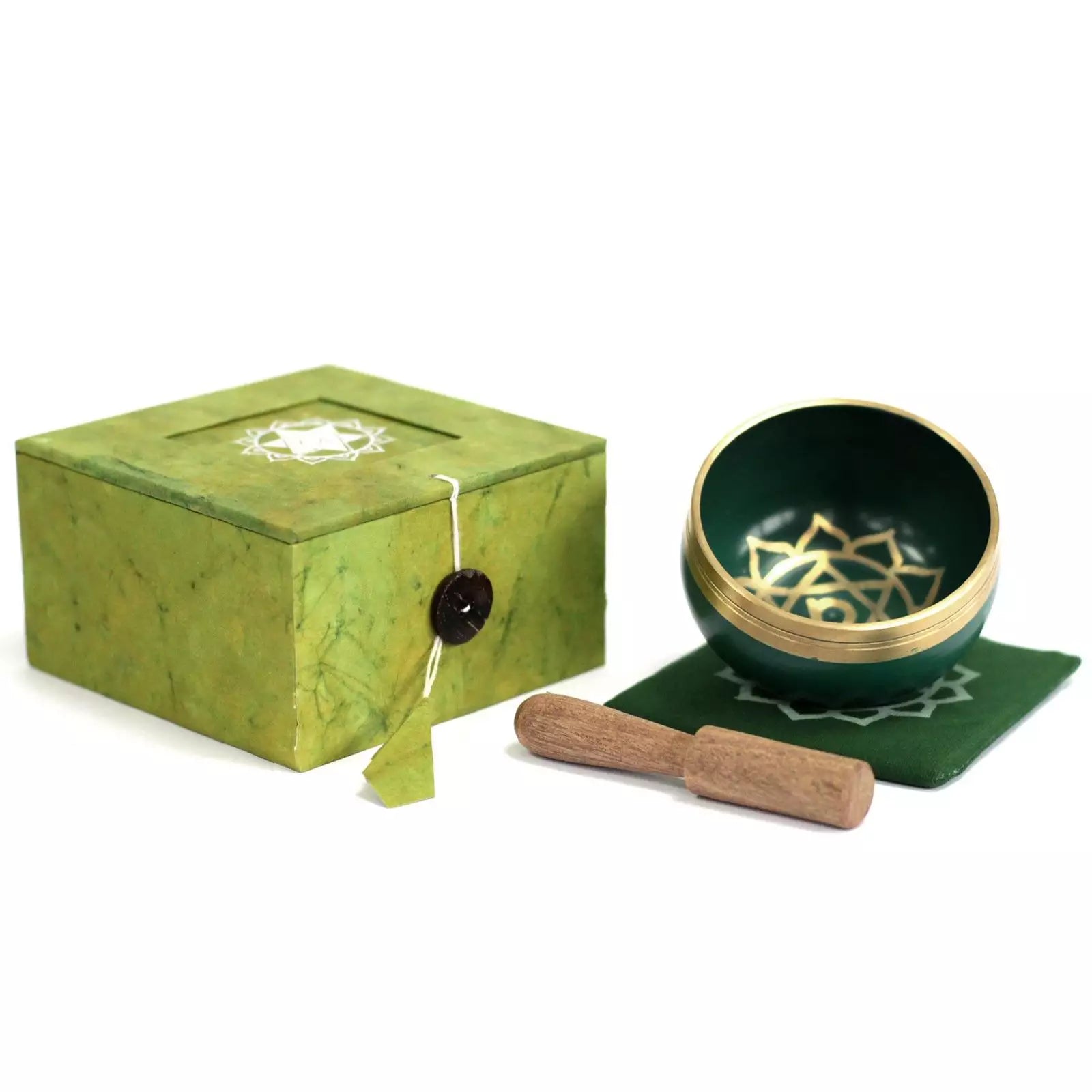 Green singing bowl set with box and wooden mallet on a white background