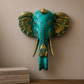Large Elephant Head - Gold & Turquoise wall sculpture featuring a striking turquoise finish with antique gold accents, perfect for adding artistic charm to home decor.