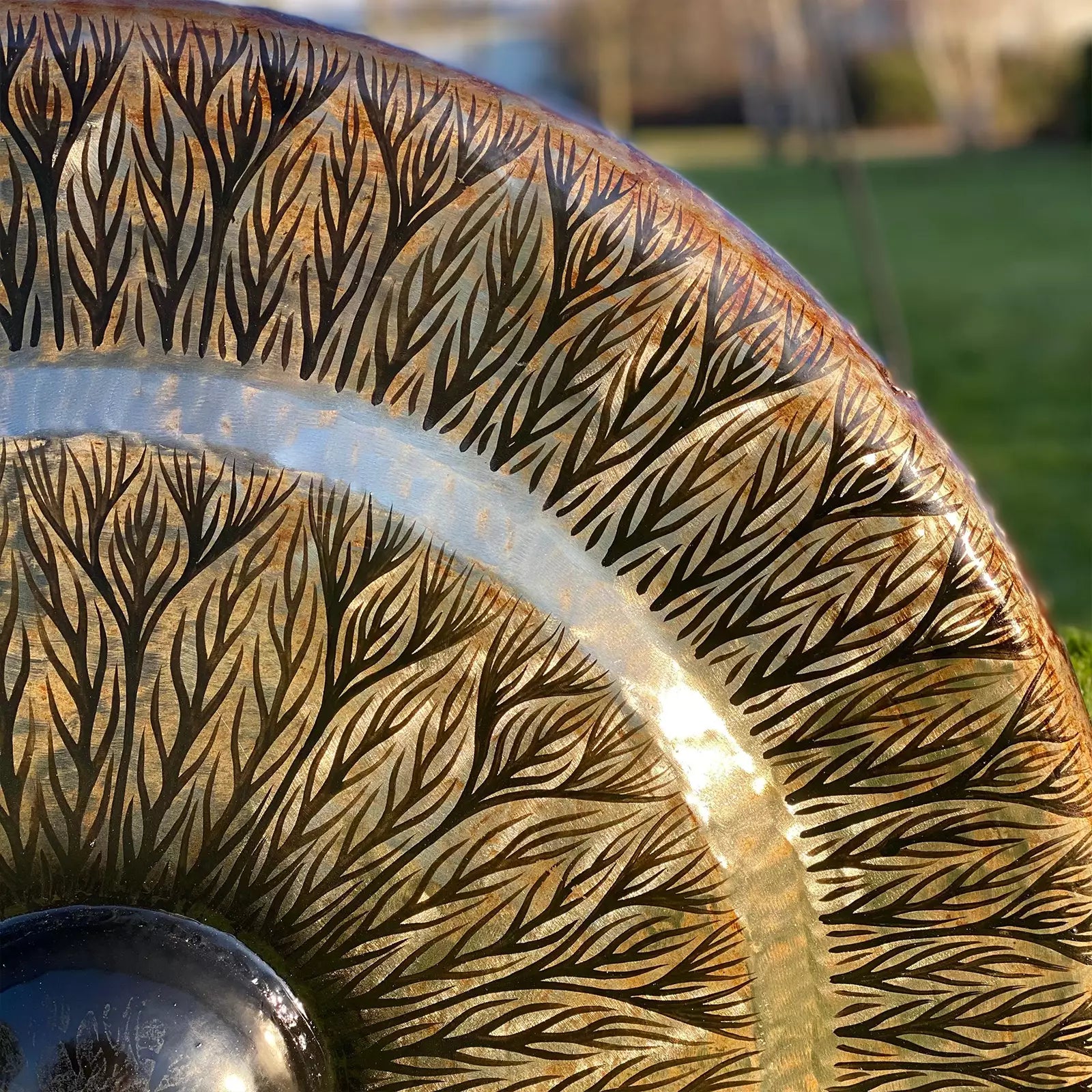 Close-up of a decorative metal object with intricate patterns outdoors
