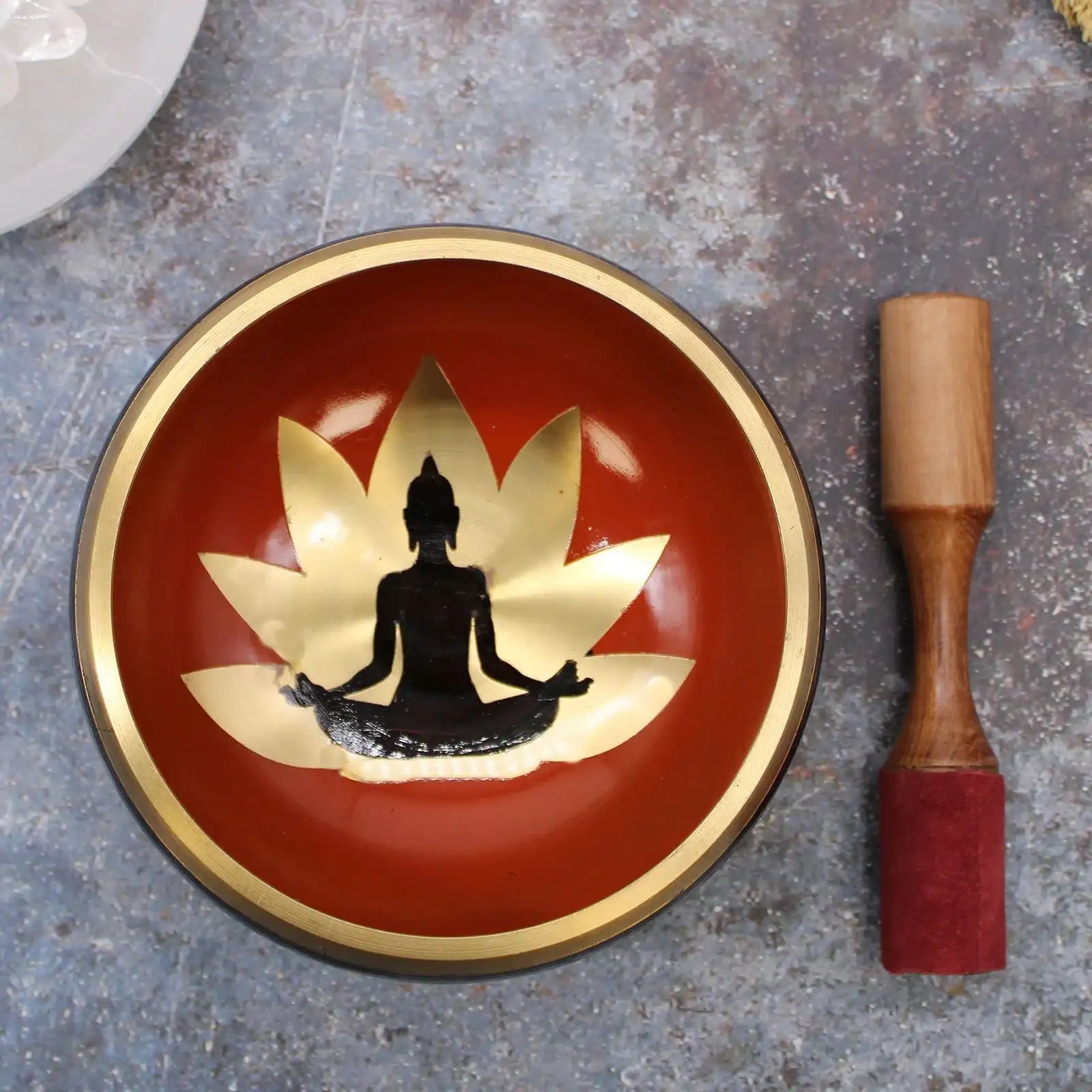 Large Buddha Singing Bowl Set- Black/Orange 14cm featuring a lotus flower and meditating Buddha silhouette inside the bowl, accompanied by a wooden striker.