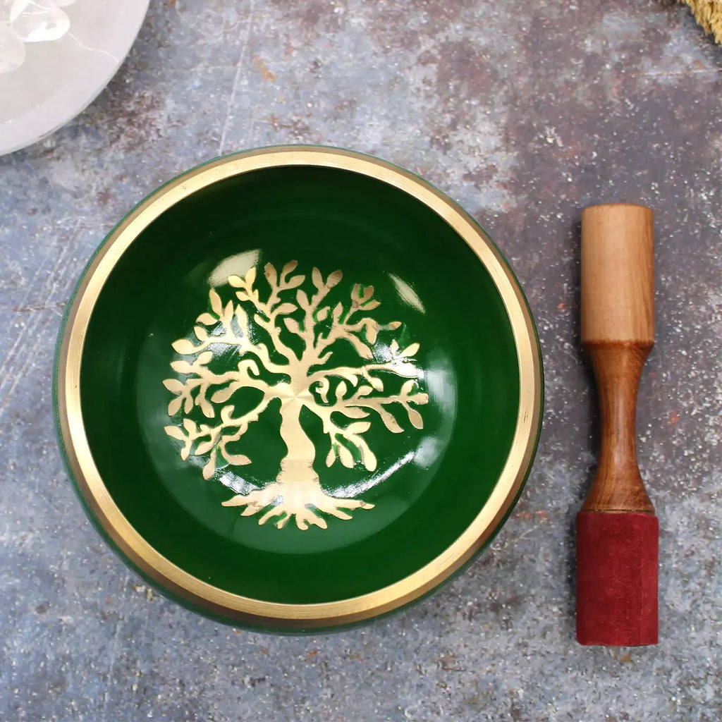 Large Tree of Life Singing Bowl Set- Green 14cm featuring a deep green bowl with a gold Tree of Life design at its center, accompanied by a wooden striker with a red suede tip.