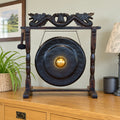 Medium Healing Gong in Wooden Stand, 35cm, Black on a sideboard in a British dining room.