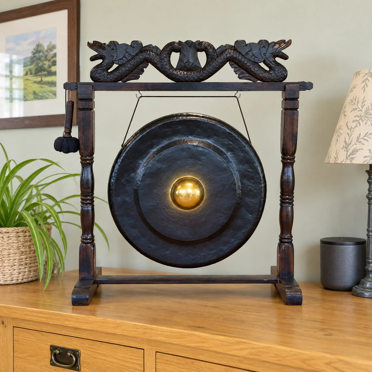 Medium Healing Gong in Wooden Stand, 35cm, Black on a sideboard in a British dining room.