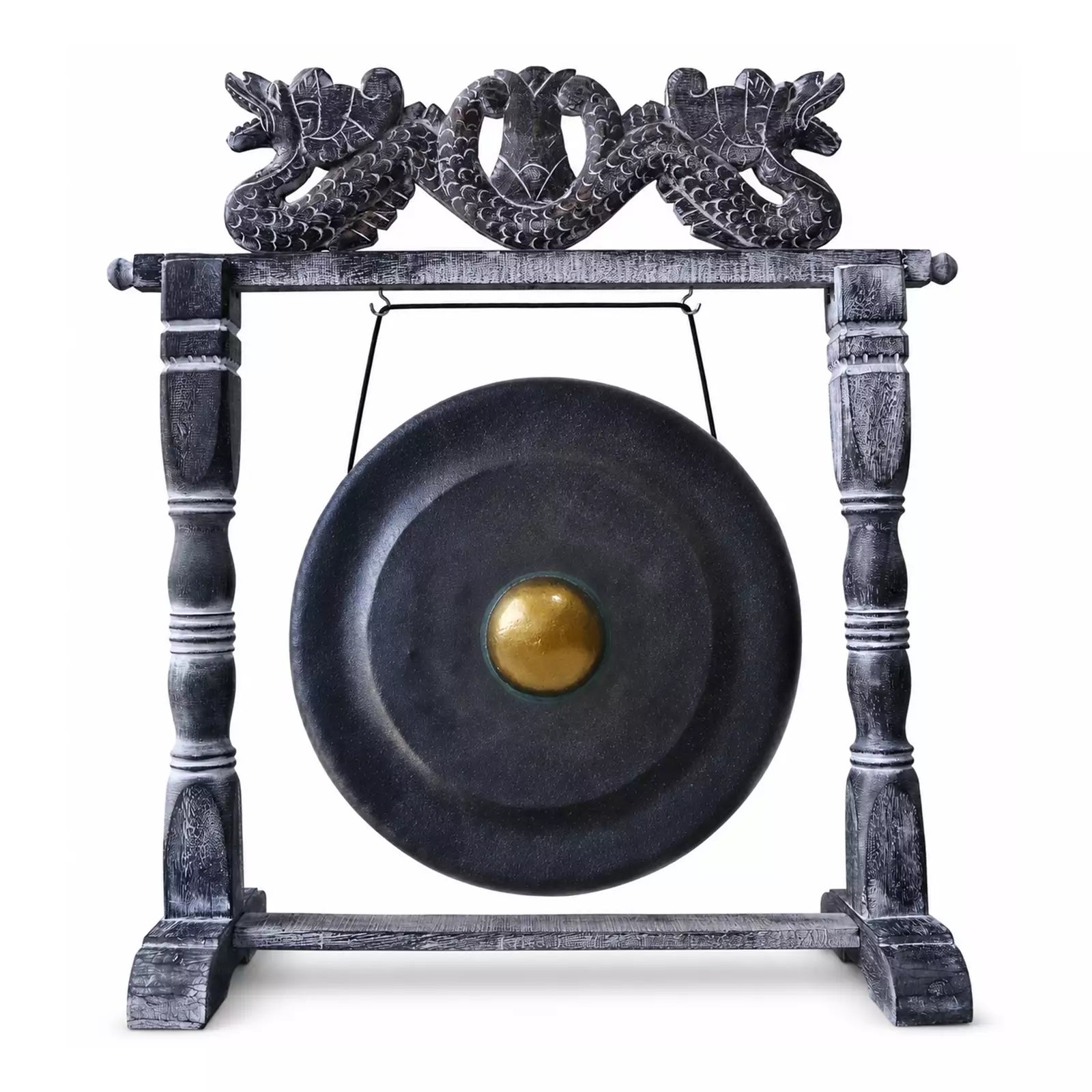 A large round black gong with a gold-colored central boss, suspended from a dark wooden stand featuring ornate dragon carvings at the top, isolated on a white background.
