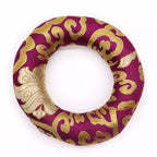 Decorative ring with gold patterns on a purple background