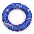 A circular blue fabric ring with a white dragon and cloud pattern, shown on a plain white background.