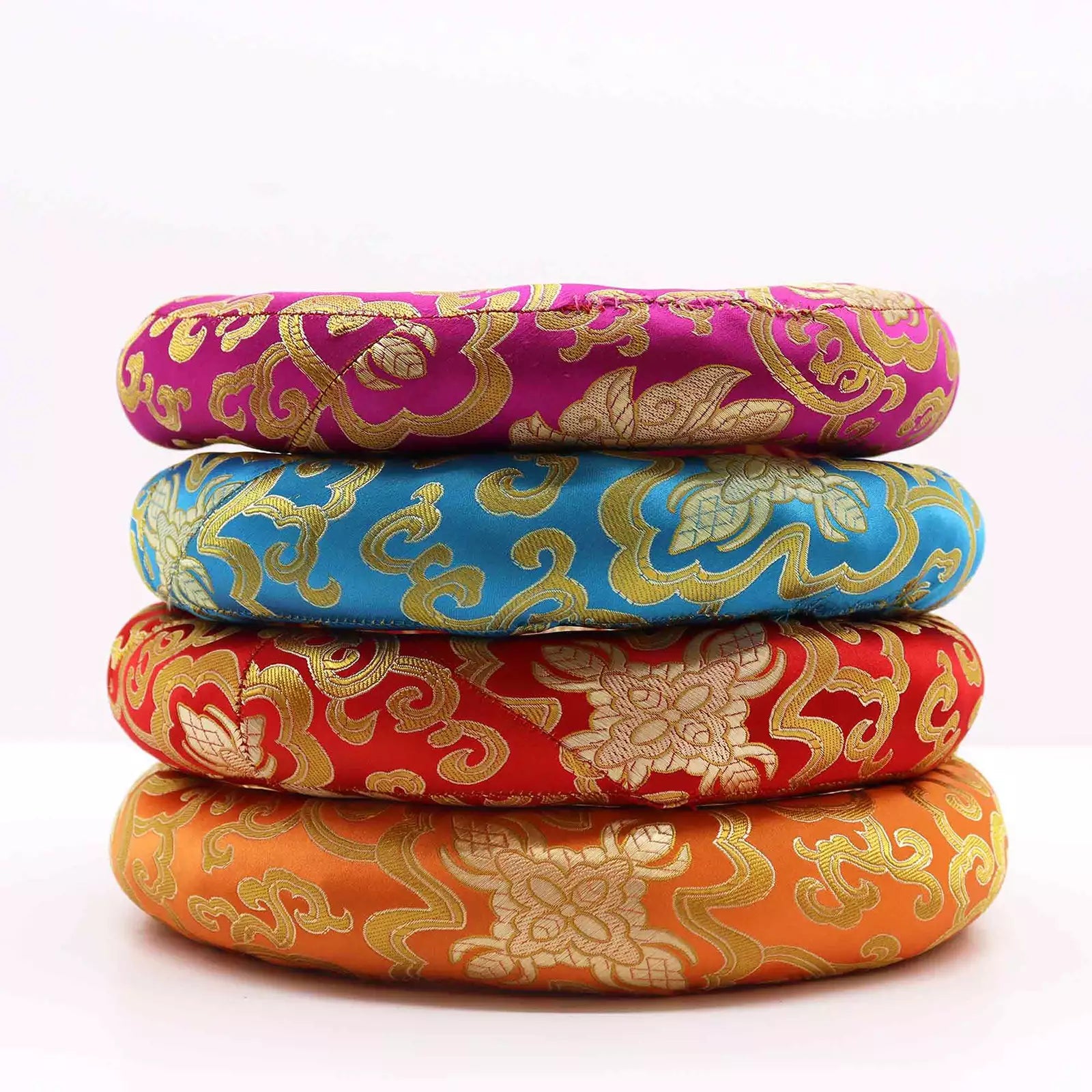 Four round woven cushion pads stacked vertically, featuring traditional Chinese brocade patterns in magenta, blue, red, and orange with gold detailing, on a white background.