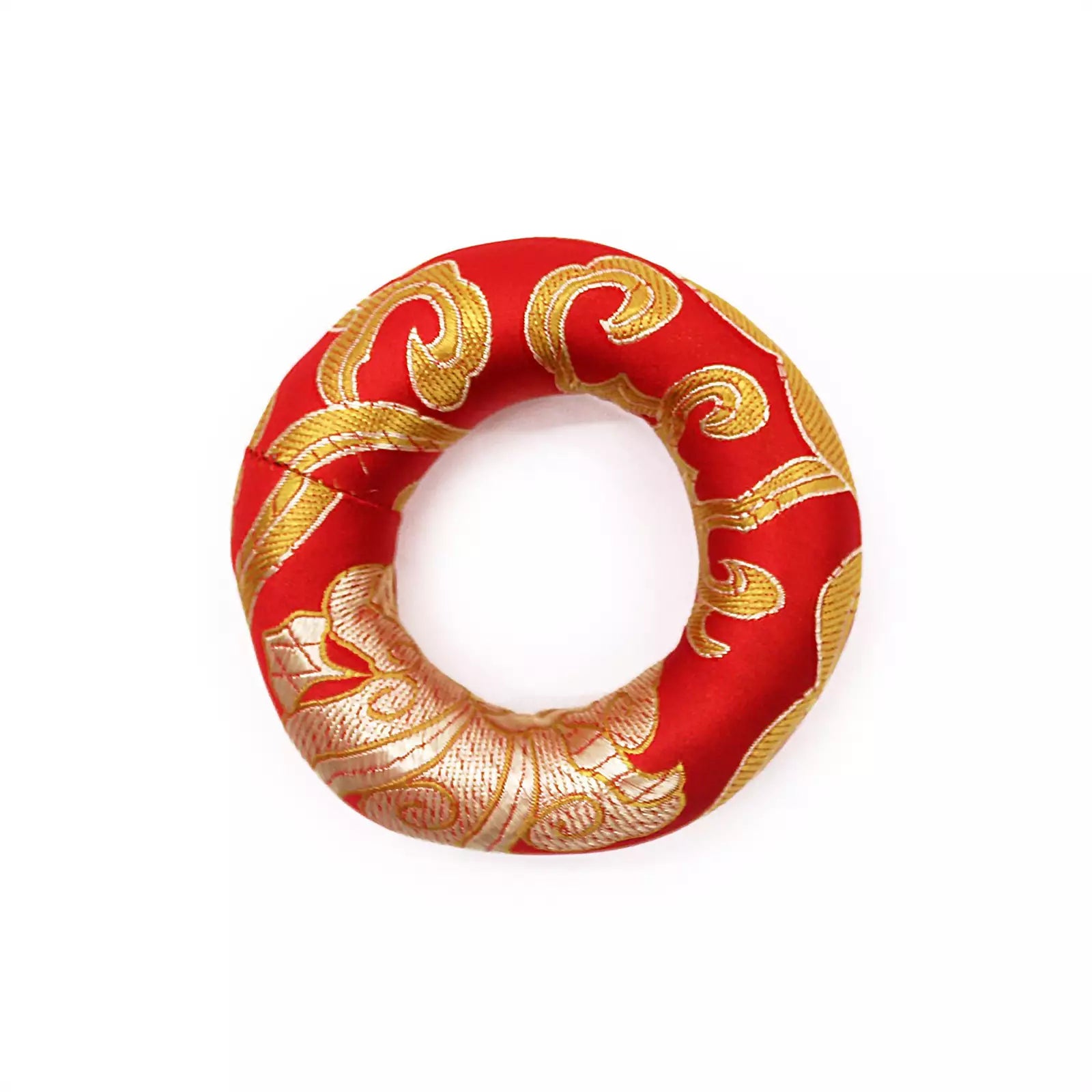 A red fabric ring-shaped cushion or pad with ornate gold woven scroll patterns, shown on a plain white background.